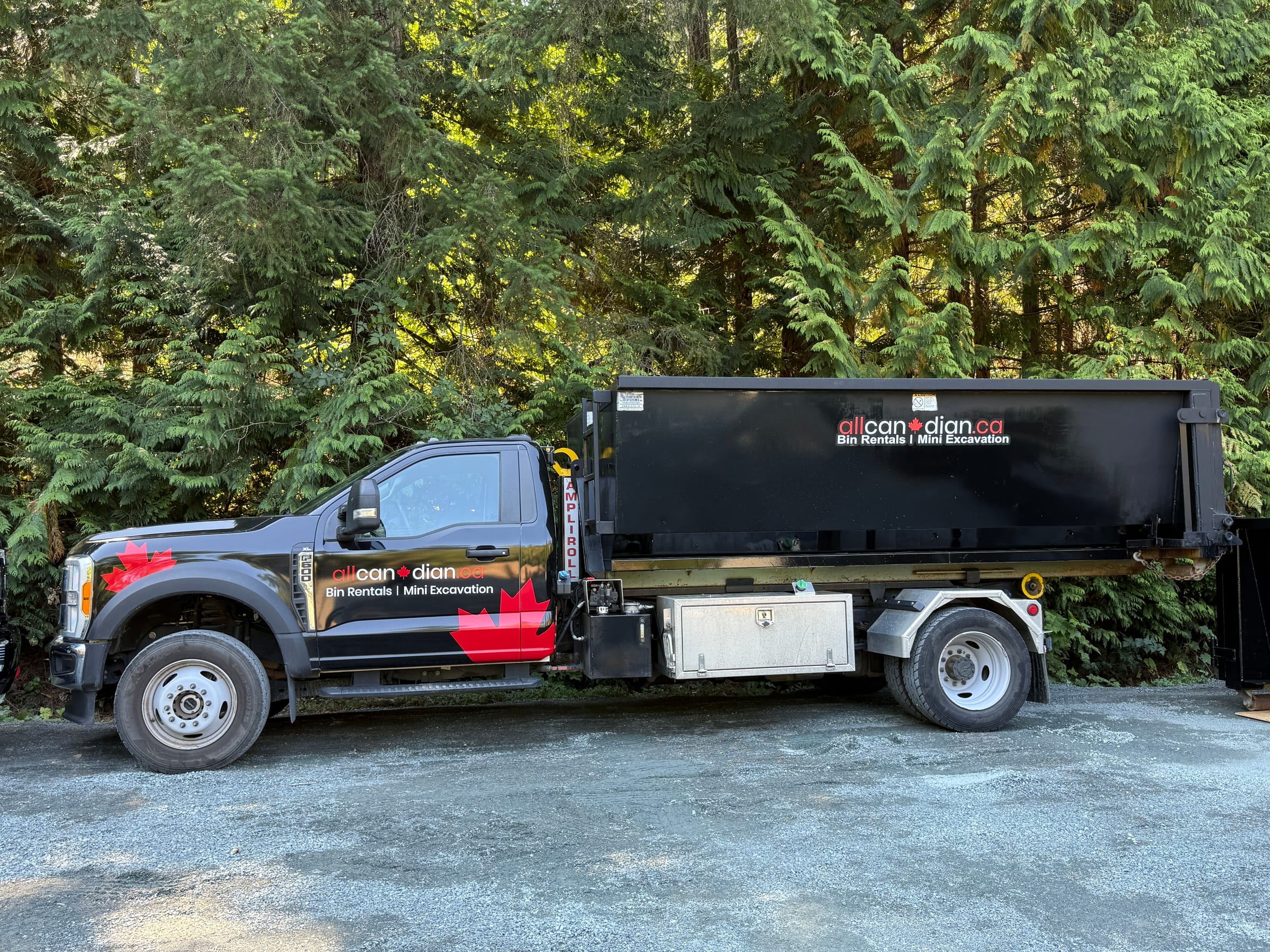 Bin rental truck delivering a disposal bin to a Parksville driveway