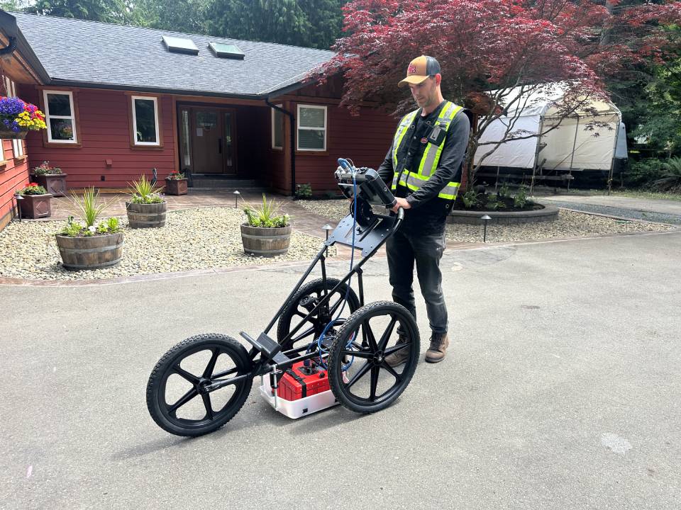 Utility locating in progress on a Vancouver Island residential property